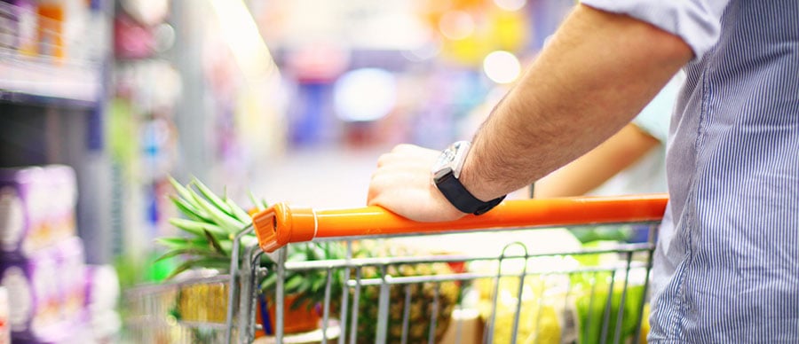 Man pushing a grocery cart Man pushing a grocery cart