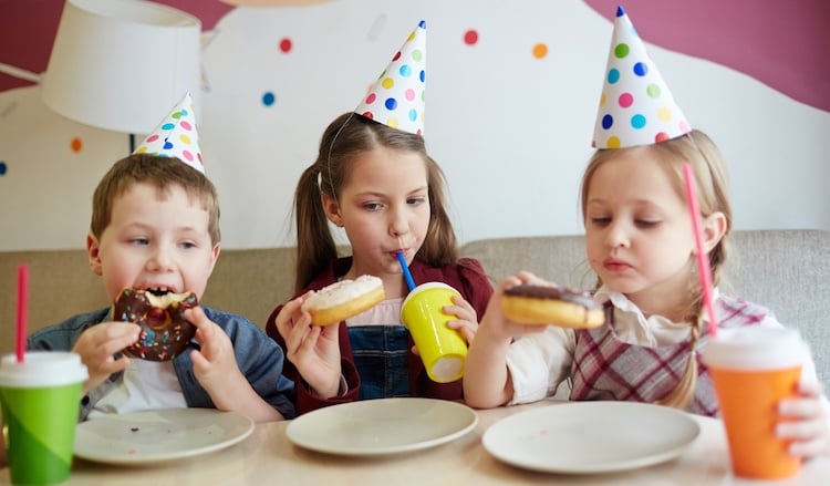 children eating donuts as a fundraiser incentive
